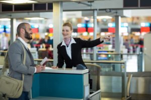 airline check attendant showing direction commuter check counter